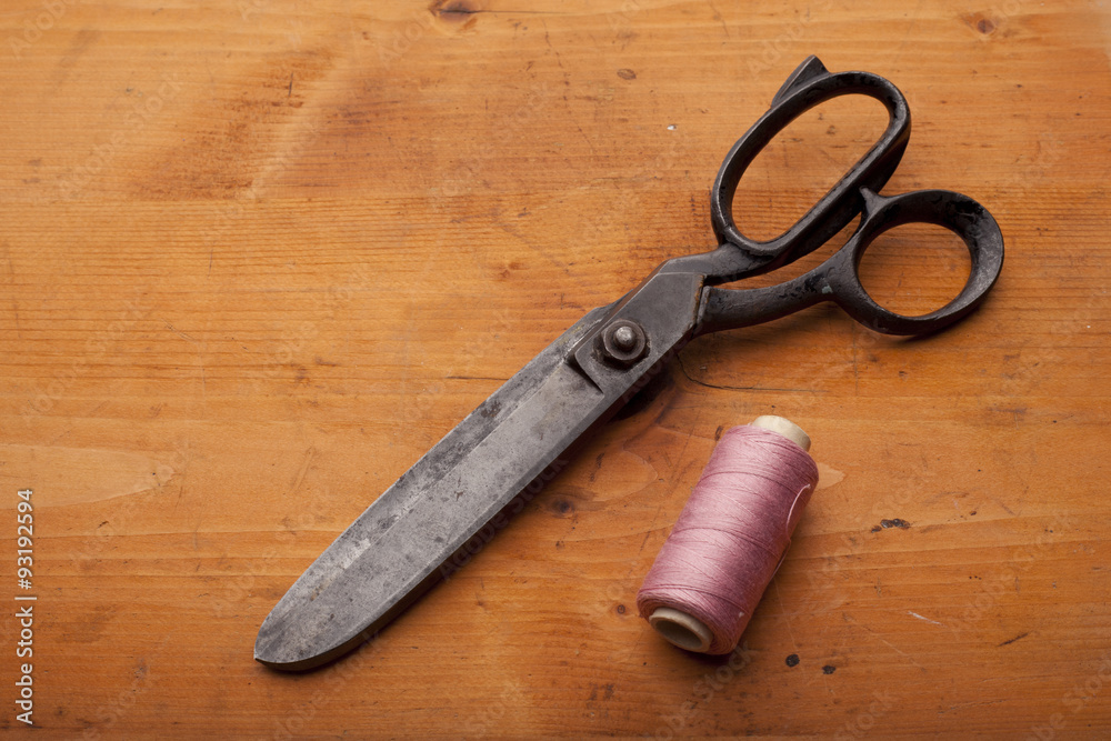 dressmaker shears craft concept with spool on wooden texture dressmaker shears craft concept with spool on wooden texture