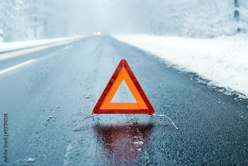 Winter Driving  - Warning triangle on a winter road