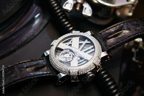 Swiss luxury watch with diamonds on the table