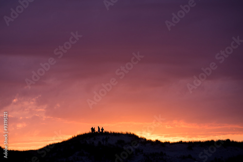 group of friends on dune at French coast