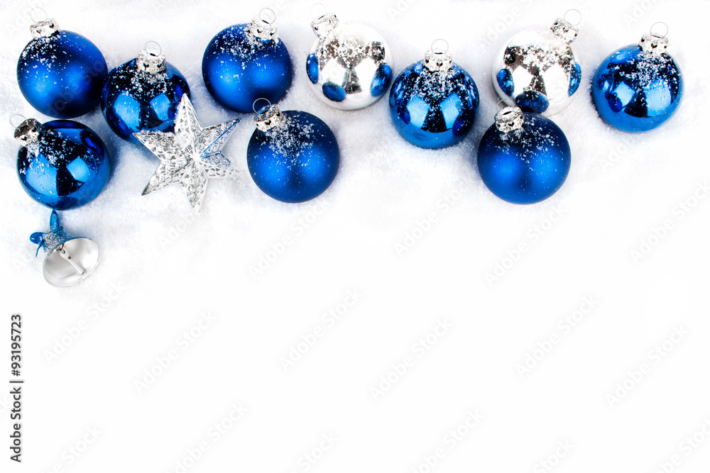 Blaue und silberne Weihnachtskugeln in Reihe und Weihnachtssterne im Schnee Blaue und silberne Weihnachtskugeln in Reihe und Weihnachtssterne im Schnee