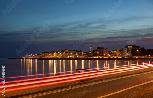 City on the bank of the ocean at night