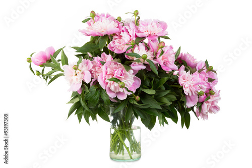 Big bouquet of pink peonies in a transparent vase, it is isolated, a white background