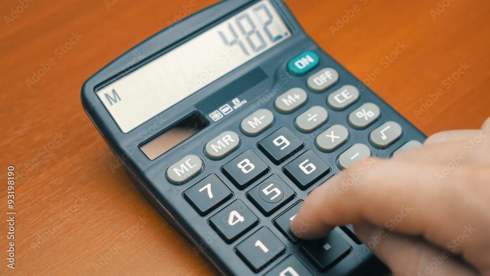 Finger presses the button calculator. The camera moves around Finger presses the button calculator. The camera moves around