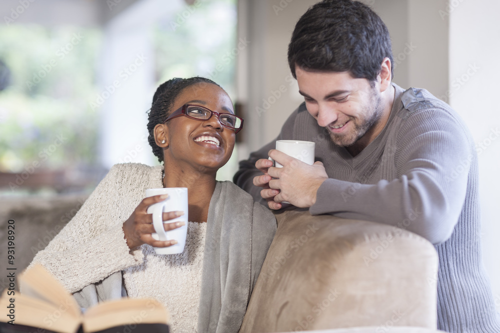 Young couple with coffee cups at home Young couple with coffee cups at home