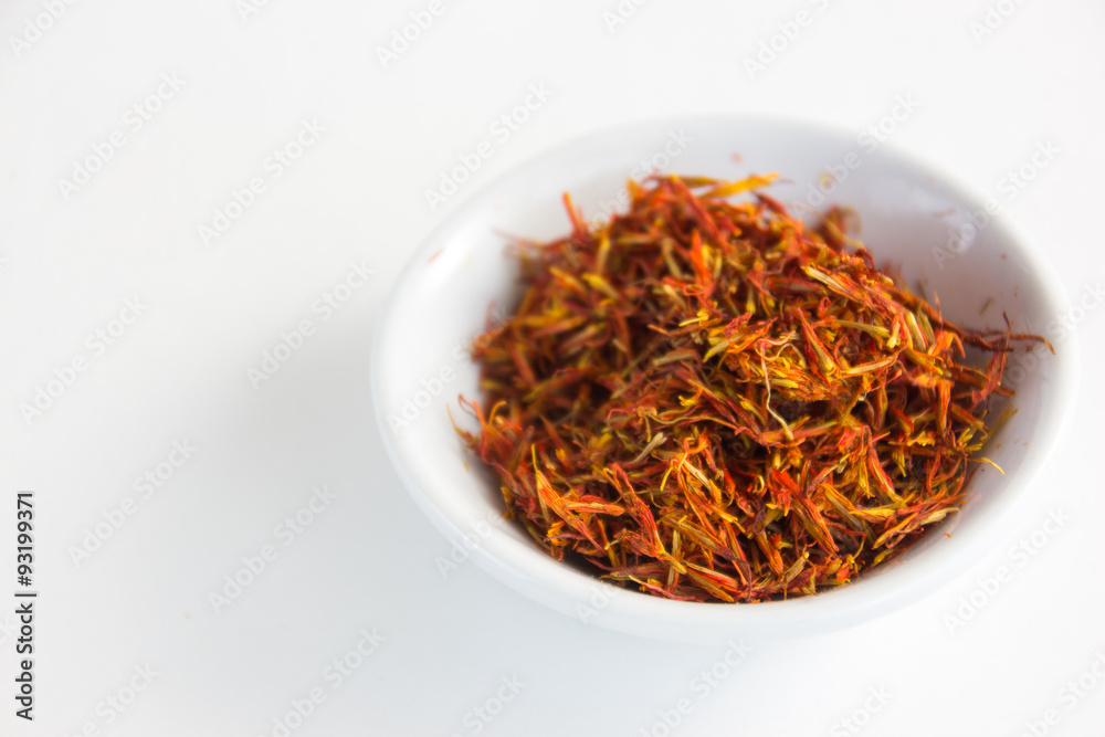 Fototapeta premium saffron in a white bowl on a white background