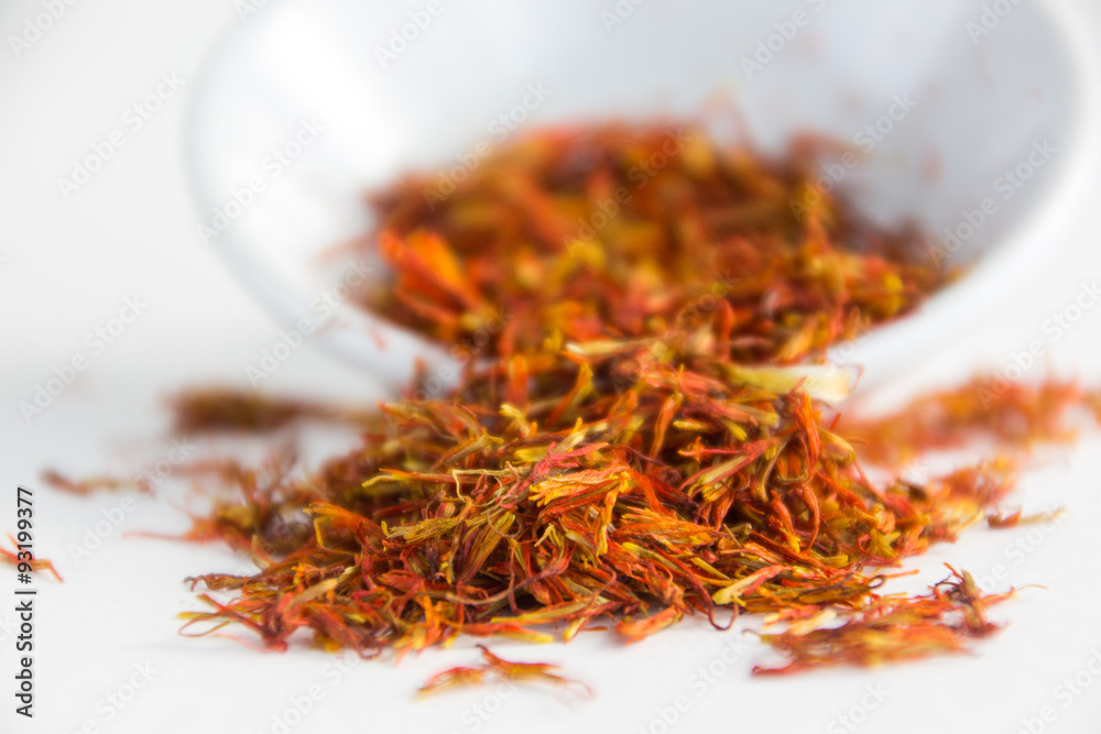 Fototapeta premium saffron in a white bowl on a wood background 