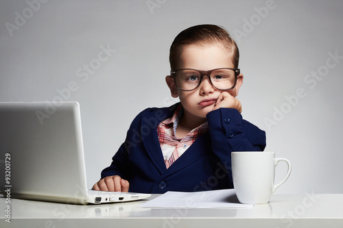 Boring job.Young business boy.funny child in glasses in office