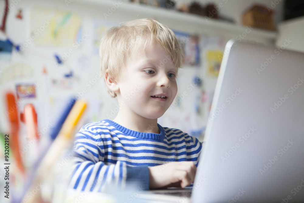 Portrait of little boy using laptop Portrait of little boy using laptop