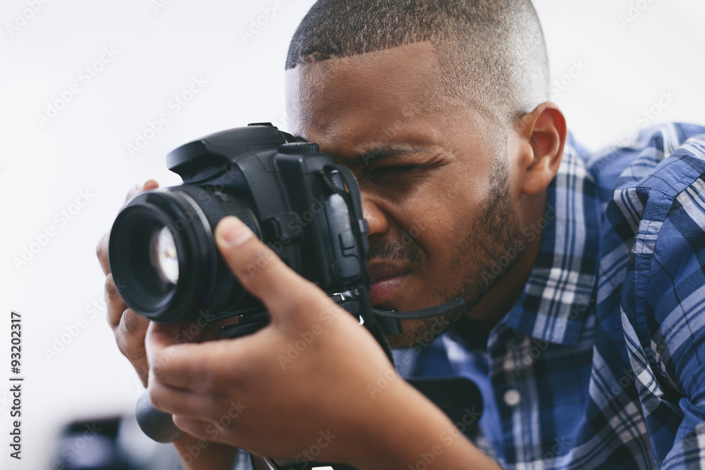 Young man at work in his photographic studio Young man at work in his photographic studio