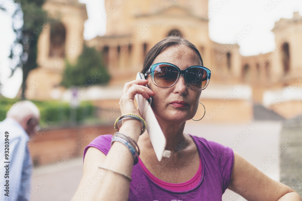 Calling brunette woman with sunglasses near San Luca, Bologna, I