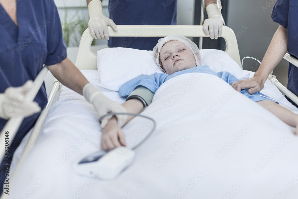 Girl in hospital bed with surgeons Girl in hospital bed with surgeons