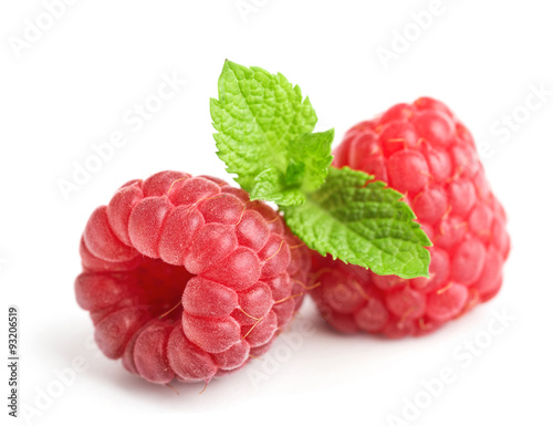 fresh ripe raspberries with mint leaves isolated on white