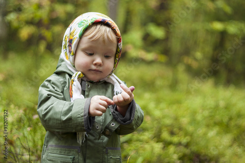 child in a kerchief at the forest