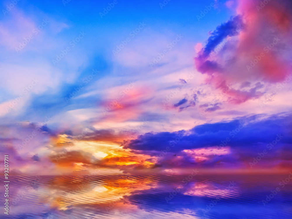 Colorful Sunset sky of deep multiple colors scaterred rays of lights and its reflection on water.