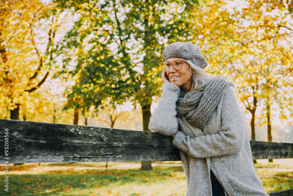 Portrait of woman wearing grey knitwear in an autumnal park Portrait of woman wearing grey knitwear in an autumnal park