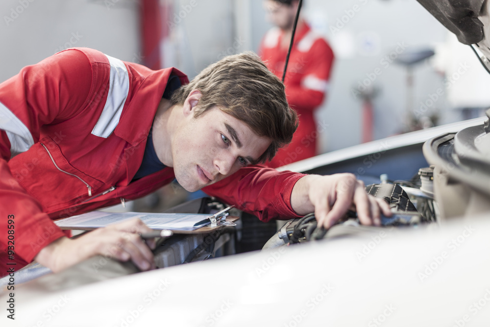 Car mechanic at work in repair garage Car mechanic at work in repair garage