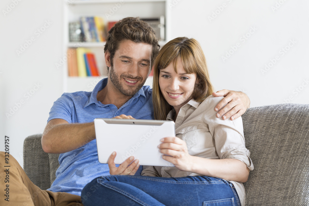 Young couple consulted their next trip on app tablet pc at home Young couple consulted their next trip on app tablet pc at home