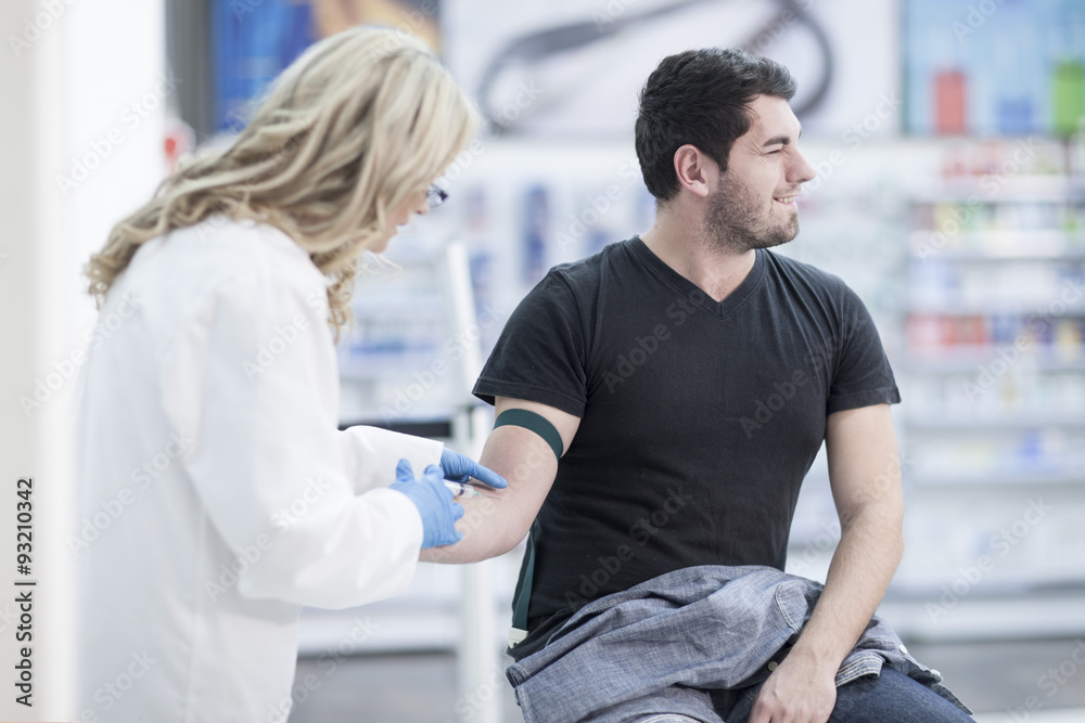 Doctor taking blood sample Doctor taking blood sample