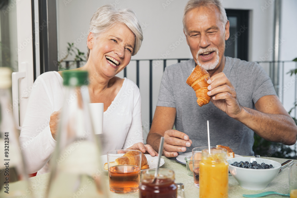 Elderly couple having breakfast at balcony Elderly couple having breakfast at balcony