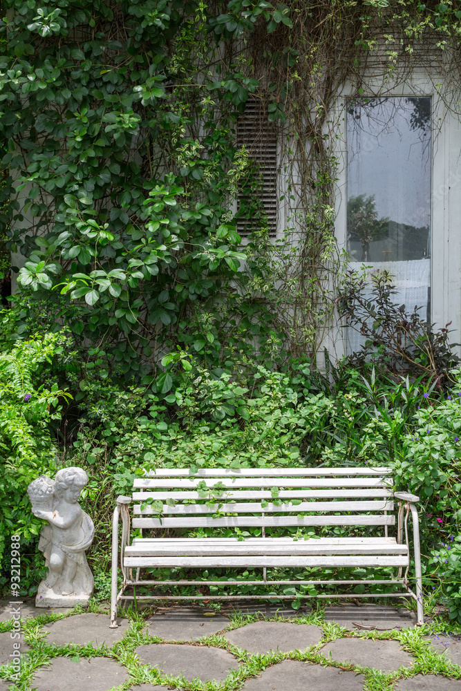 White alloy bench in outdoor garden White alloy bench in outdoor garden