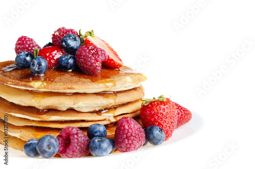 Pancakes with berries and honey over white
