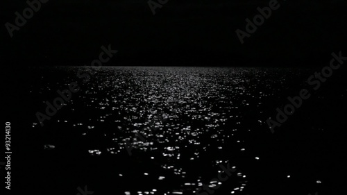 Moonlight reflecting from nightly lake photo