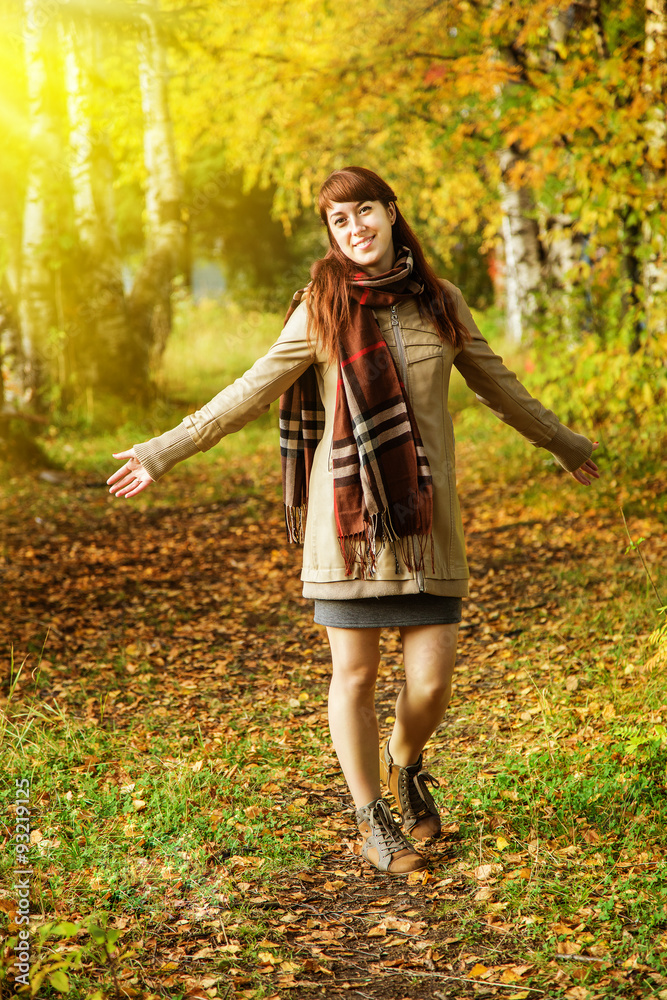 Cute girl walking in the autumn park Cute girl walking in the autumn park