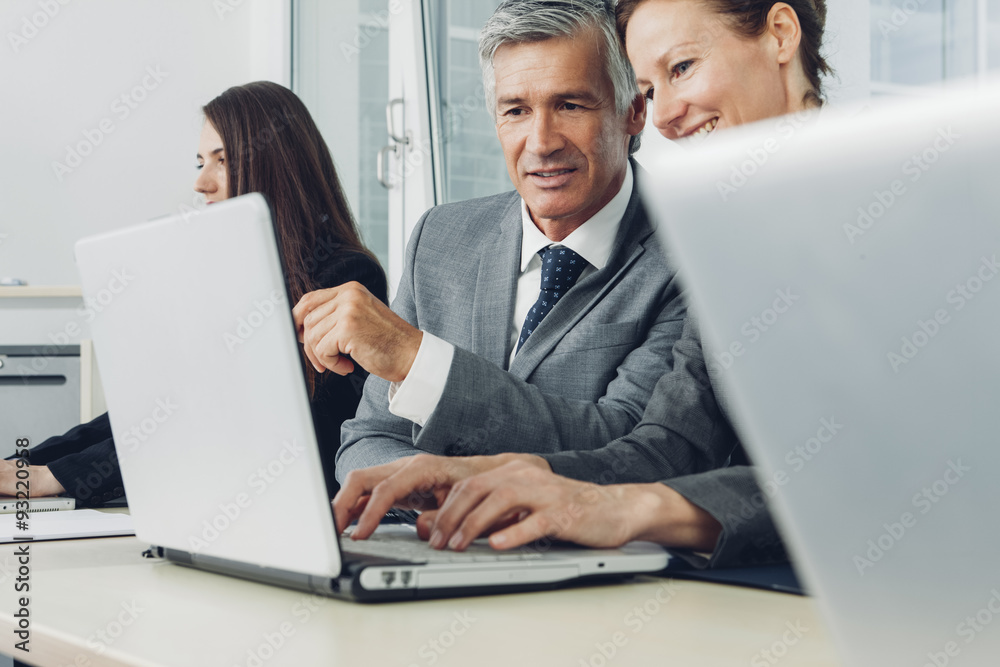 Business people in office working at laptop Business people in office working at laptop
