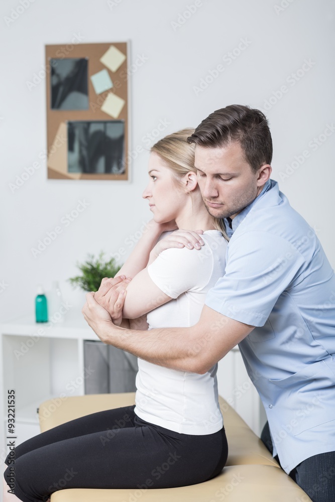 Fototapeta premium Chiropractor helping woman with pain