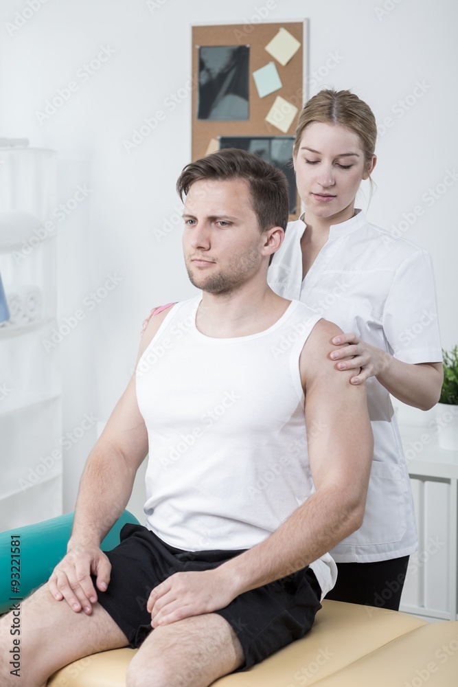 Fototapeta premium Therapist examining athletic man
