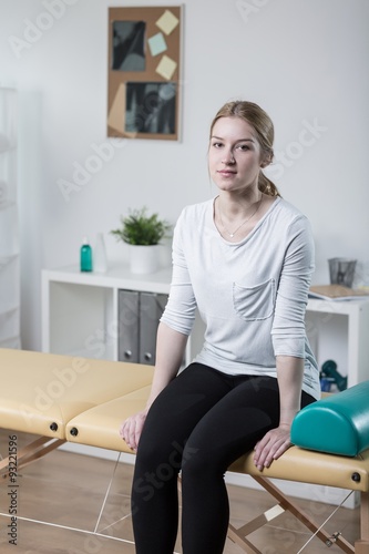 Patient sitting on physiotherapy plinth