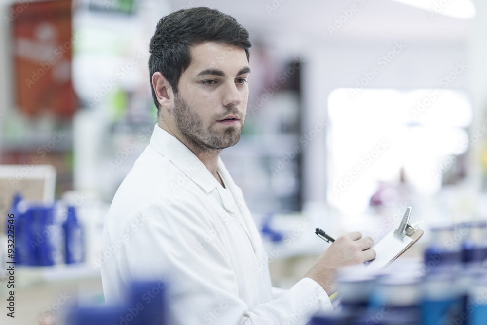 Pharmacist taking stock at drugstore Pharmacist taking stock at drugstore