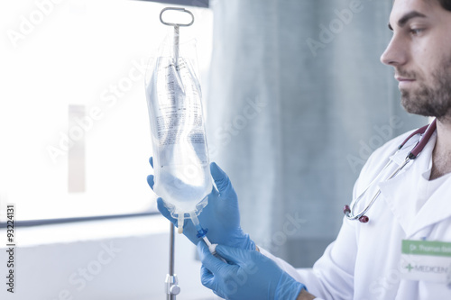 Nurse adjusting intravenous drip