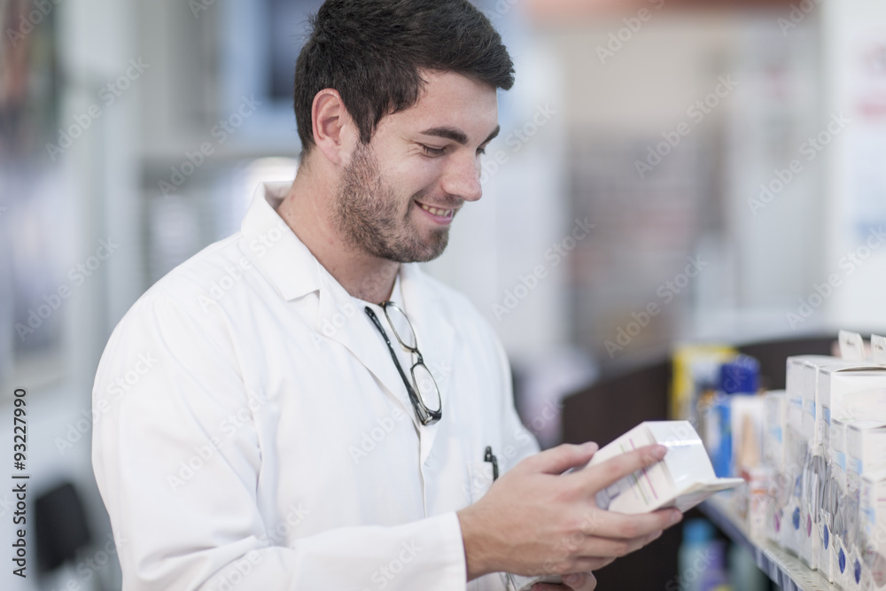 Pharmacist taking stock at drugstore Pharmacist taking stock at drugstore