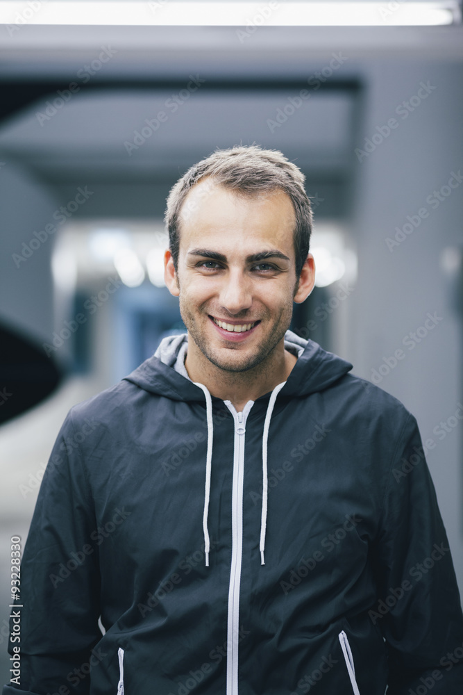 Portrait of smiling man wearing black hooded jacket Portrait of smiling man wearing black hooded jacket