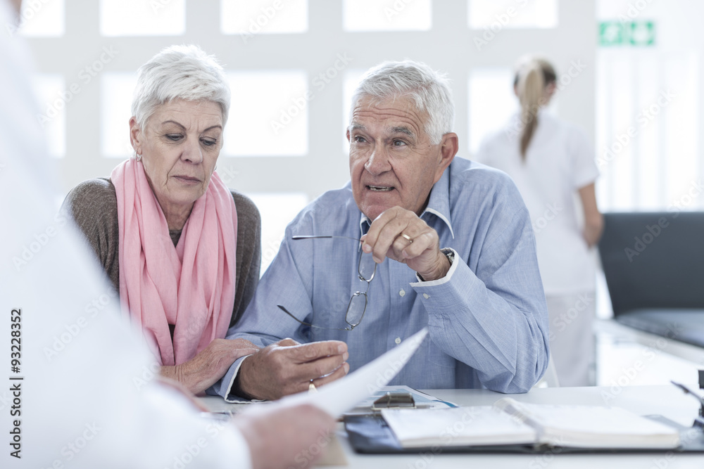 Senior couple consulting doctor