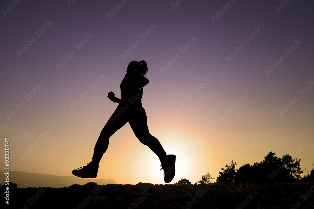 Young woman running on a rural road. Lifestyle sports background.