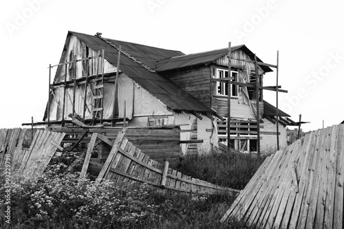 black and white photo of the destroyed wooden house #93229798