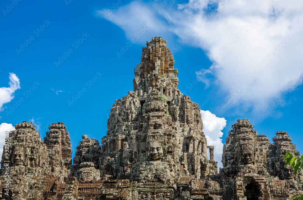 Ancient stone faces Bayon temple in Angkor Thom, Siemreap, Cambo