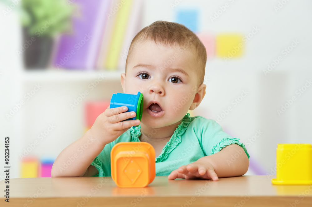 Baby girl playing with block toys