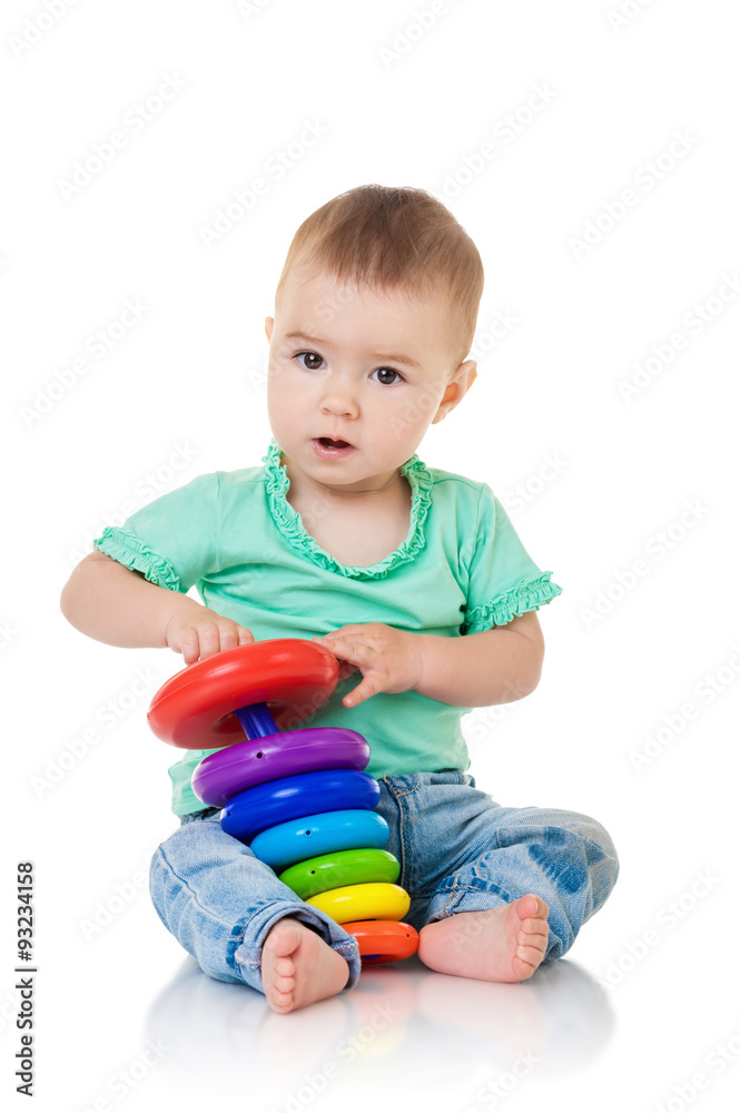 Baby girl playing with a pyramid toy, isolated on white Baby girl playing with a pyramid toy, isolated on white