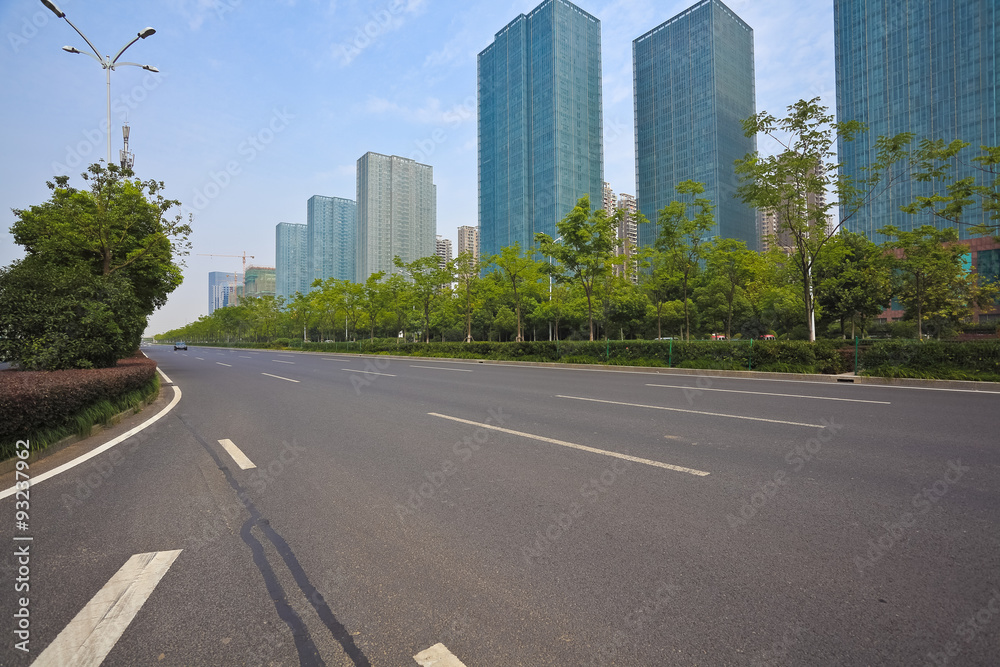 Empty road surface with modern city buildings background