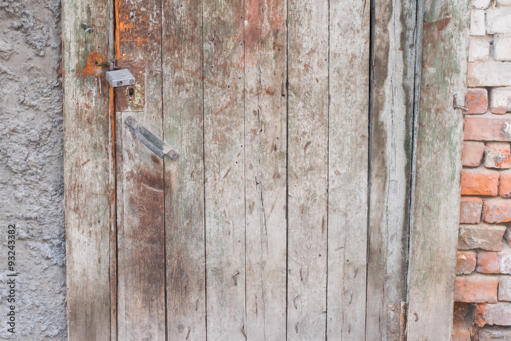 Old wooden door in the evening. The texture and color of the door. Old wooden door in the evening. The texture and color of the door.