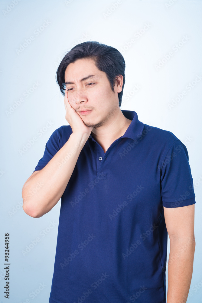 Asian guy having toothache holding his face with his hand, Asian guy having toothache holding his face with his hand,