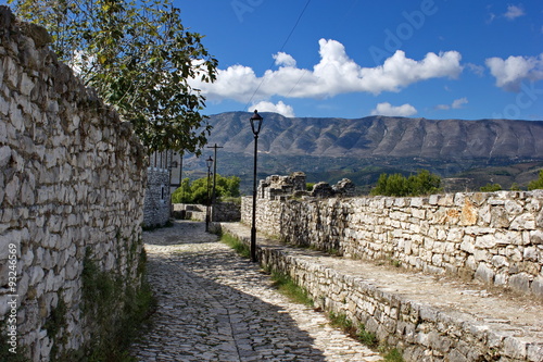 stone walls of old fortress and mountains in background, Berat, Albania