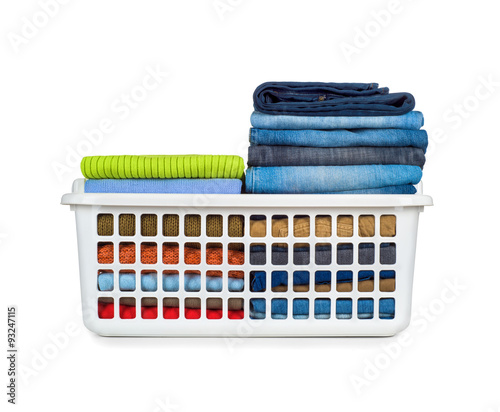Tableau sur toile Laundry basket with folded clothes over white background
