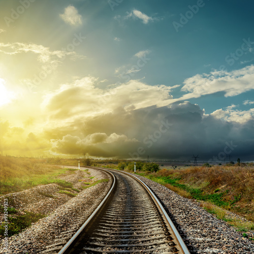 railroad to horizon and sunset in clouds