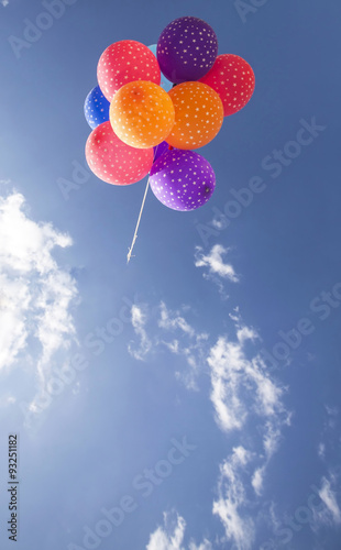 Colorful balloons flying on the blue sky
