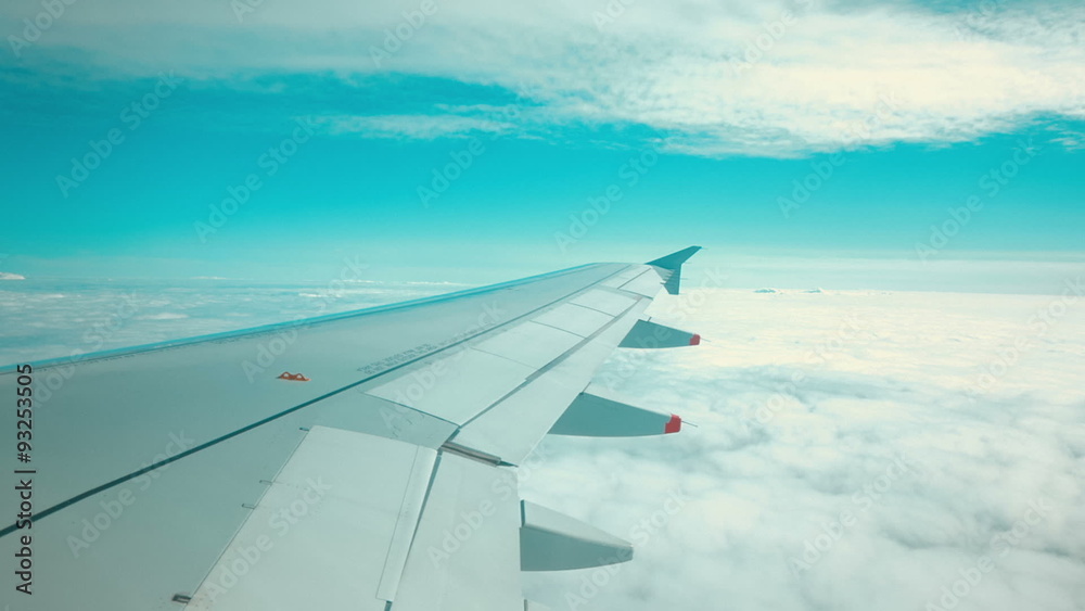 A right wing view of an aeroplane flying in between two layers of clouds
A right wing view of an aeroplane flying in between two layers of clouds